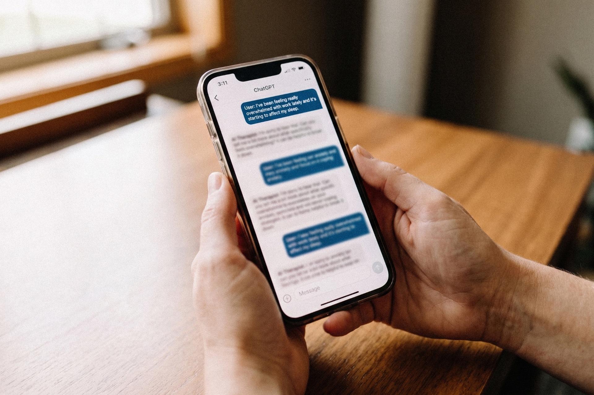 Hands holding a phone showing a ChatGPT conversation about feeling overwhelmed