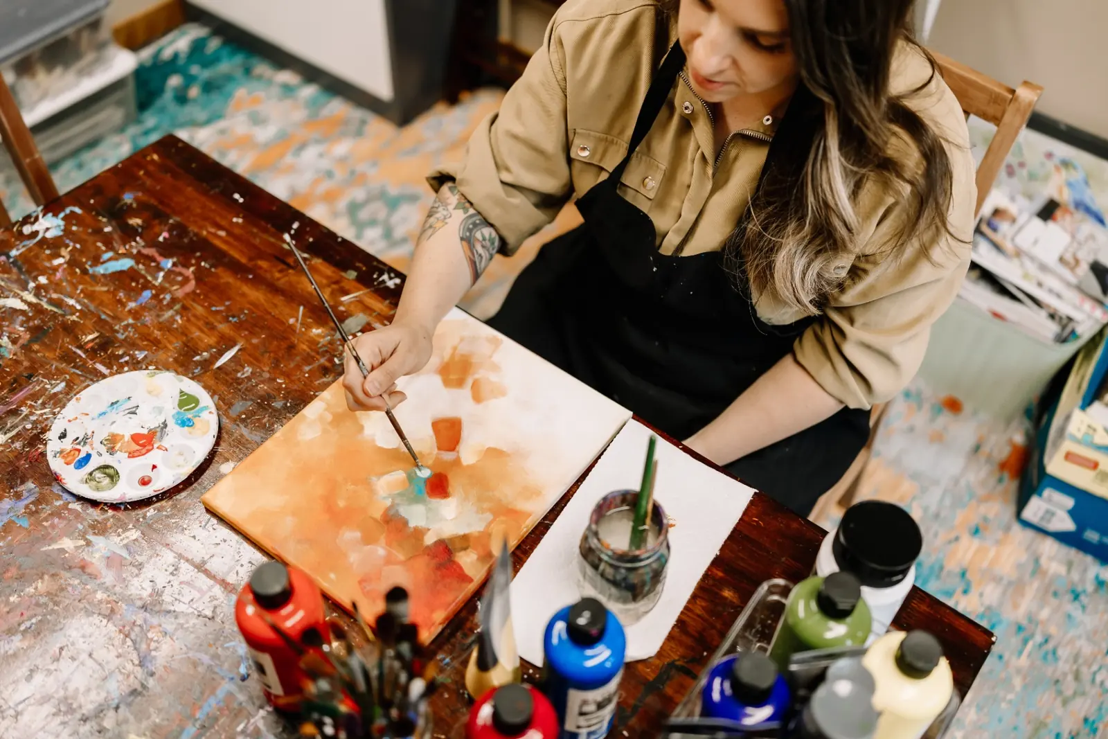 A therapist creating watercolor art in MK Counseling's art therapy studio