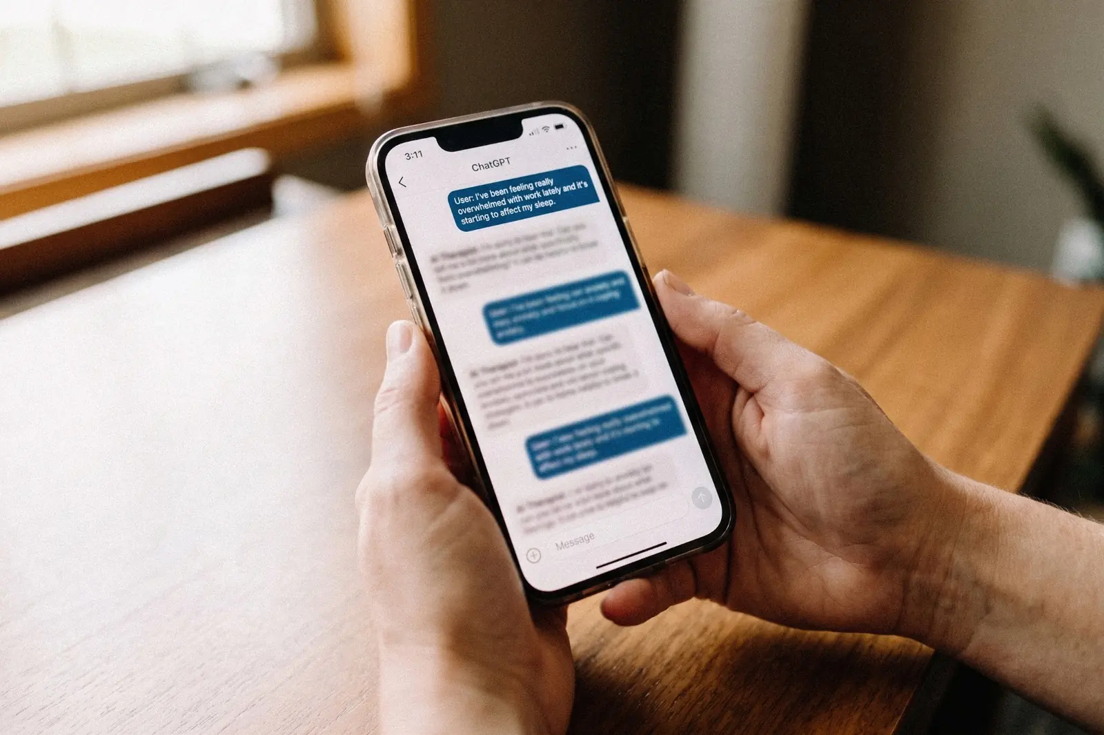 Hands holding a phone showing a ChatGPT conversation about feeling overwhelmed